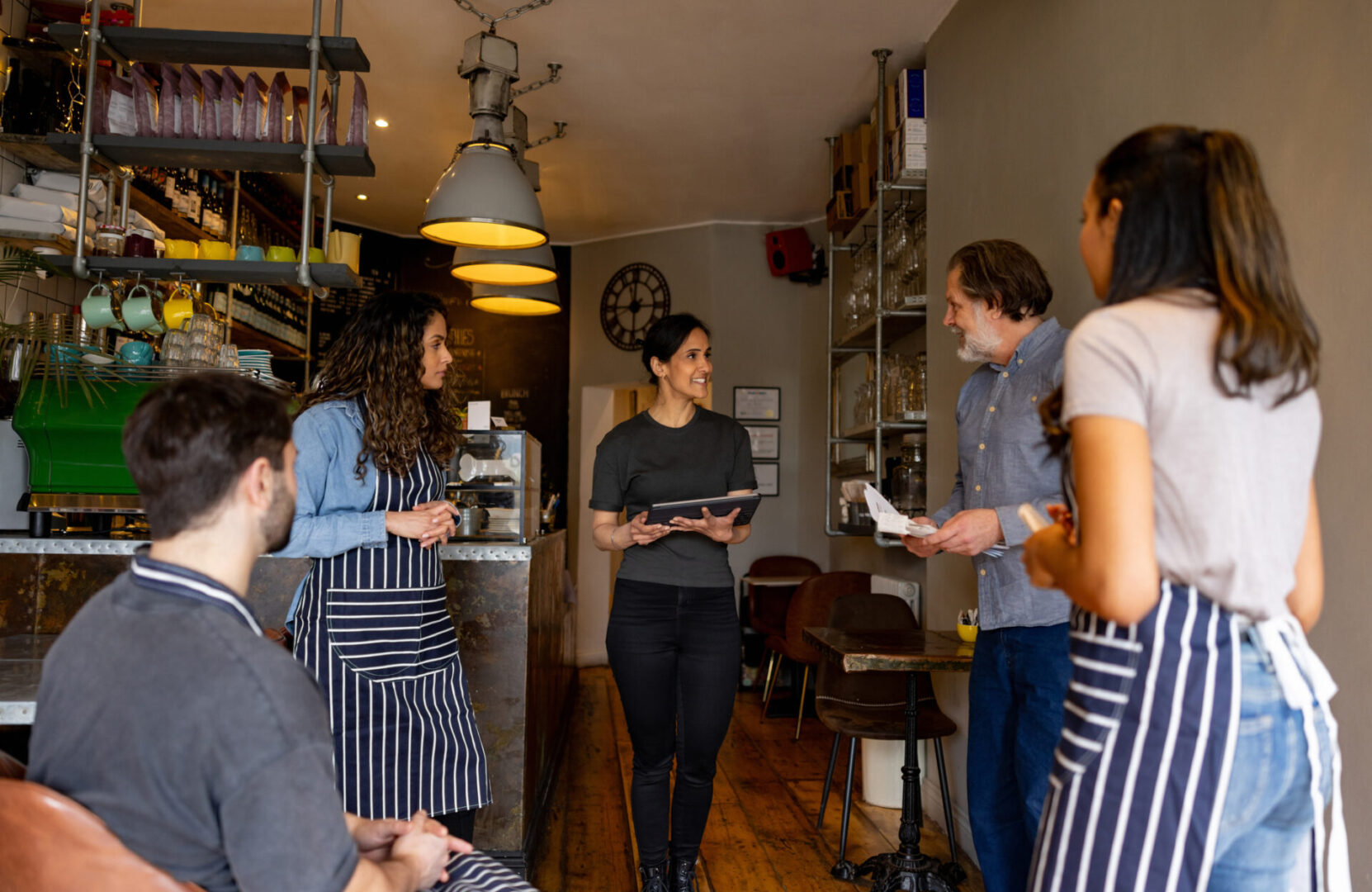 Cafe staff having a meeting inside.